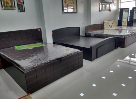 : Luxurious king-size bed with an upholstered headboard and wooden frame, perfect for a modern bedroom.